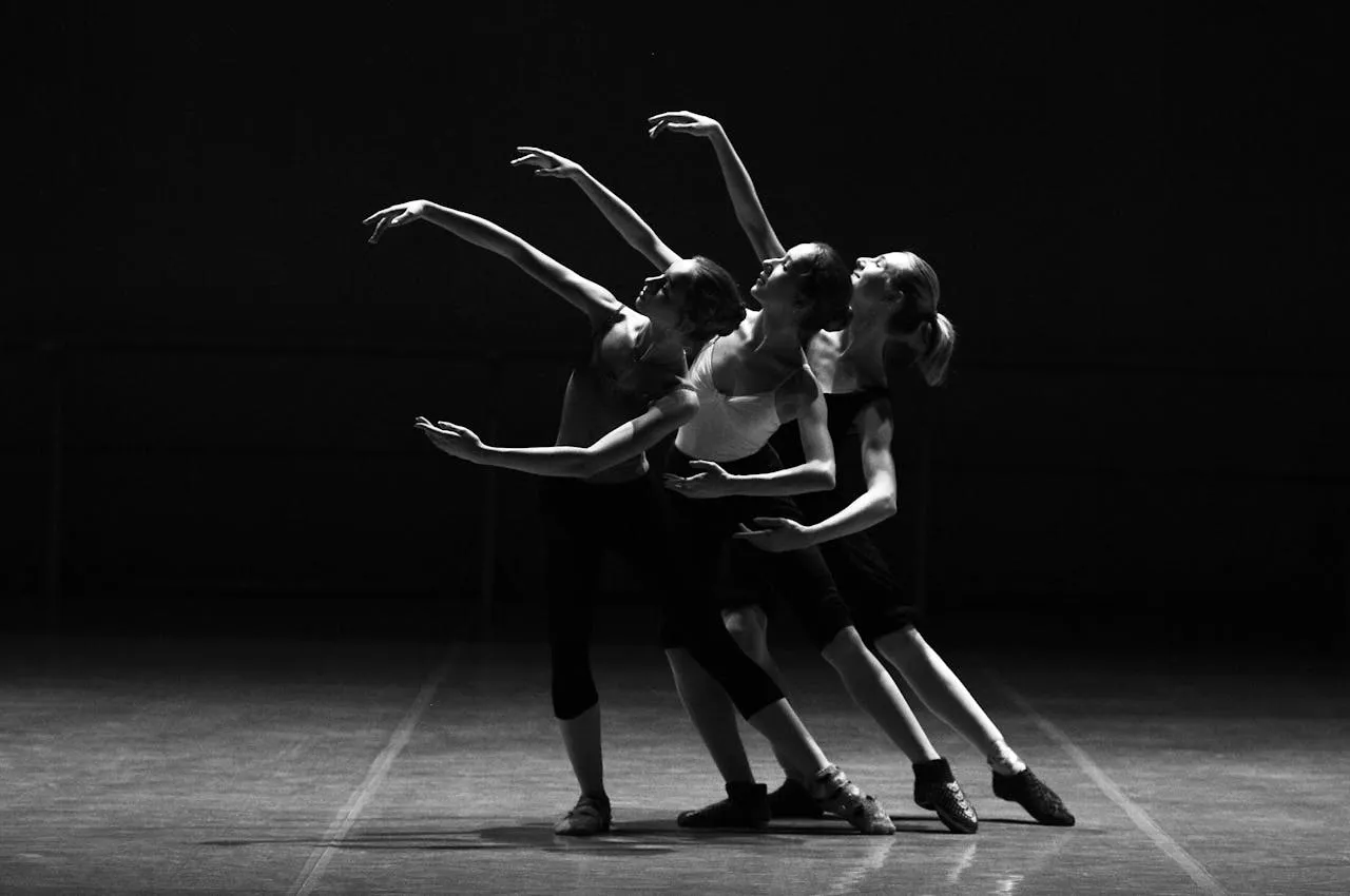 Trois danseuses en mouvement coordonné lors d'un événement.